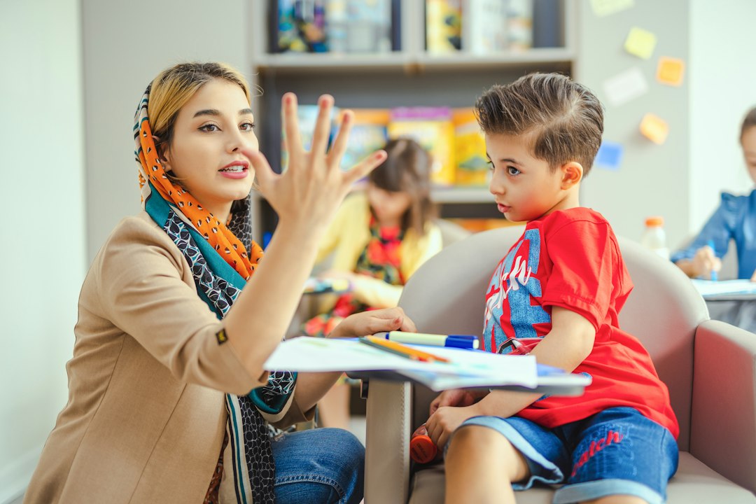 Teacher using finger gestures while explaining an activity to a child