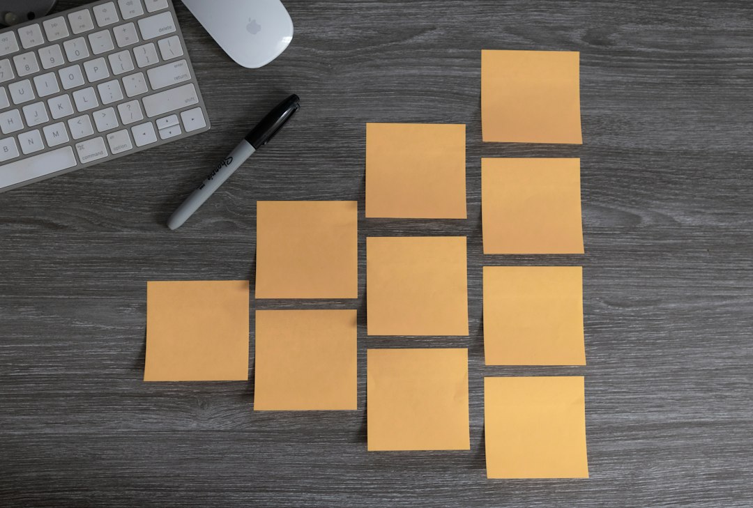 Blank colourful sticky notes and a marker on a desk