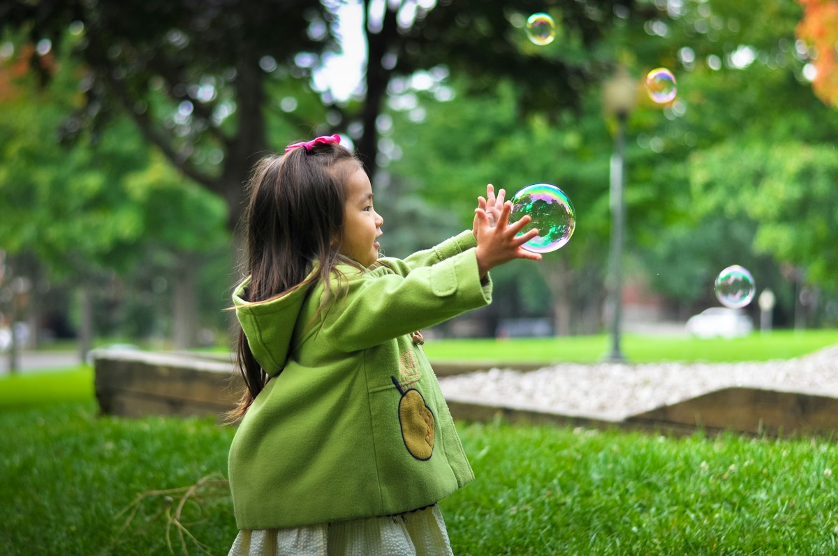 Child enjoying bubbles during outdoor play