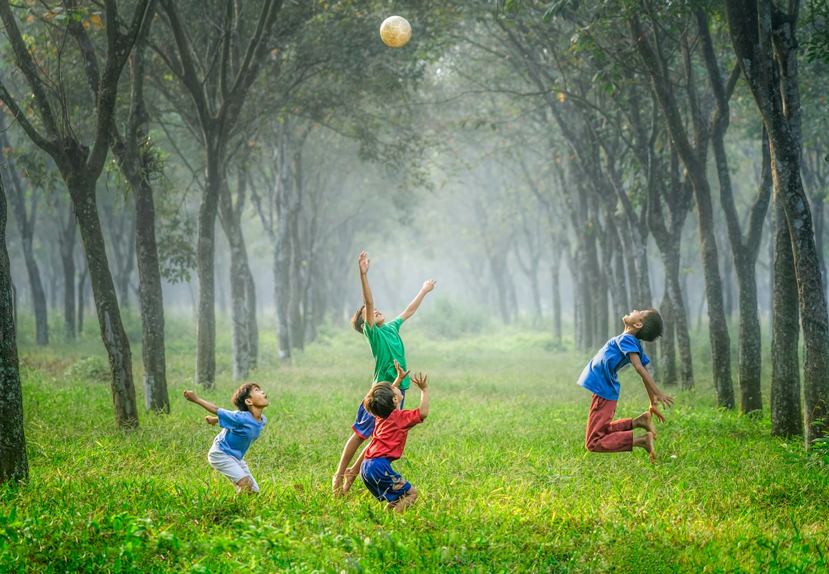 Children playing a group ball game outdoors